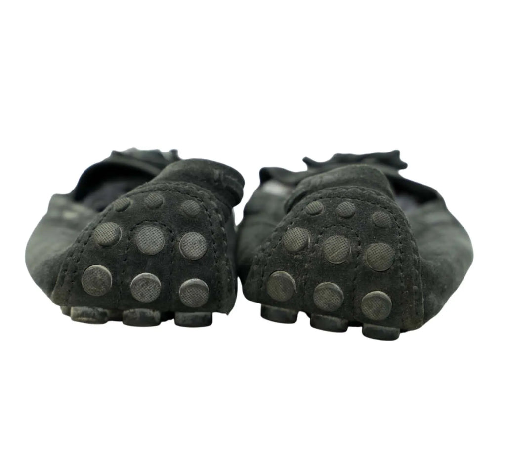 editorial style Louis Vuitton black suede loafers with tassel detail styled with formal outfit
